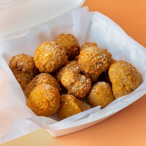 Golden-brown fried seafood bites, likely from Hip Hop Fish and Chicken, served in a white takeout container.